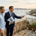 Agent and clients viewing luxury Riviera villa terrace