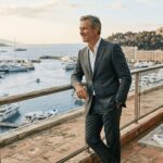 Investor on Monaco balcony overlooking Riviera