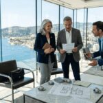 Couple reviewing property documents French Riviera lounge