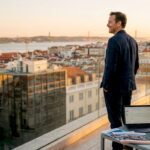 Advisor overlooking Lisbon skyline in penthouse