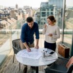 Couple on penthouse balcony with city skyline