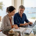 Two professionals reviewing Riviera investment details