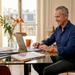 Investor reviewing luxury property listings at table