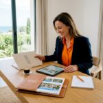 Advisor reviewing Riviera luxury property dossiers