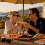 Happy couple enjoying terrace drinks at beach