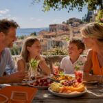Happy family enjoying drinks and food on terrace
