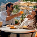 Happy couple enjoying snacks on sunny beach terrace