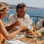 Family enjoying sunny luxury terrace with drinks