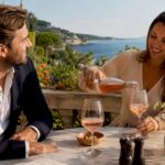Couple pouring wine and discussing property