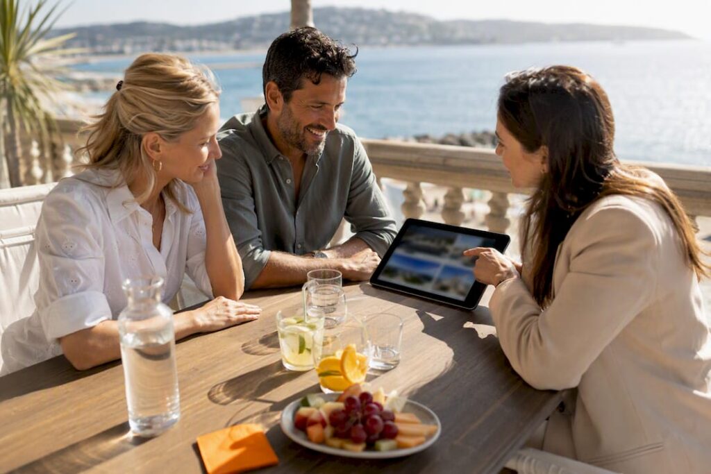 Couple and buyer agent reviewing Riviera properties
