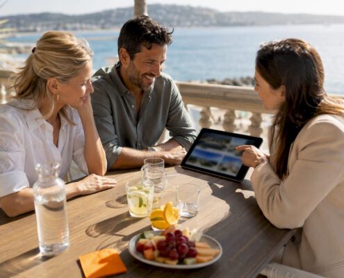 Couple and buyer agent reviewing Riviera properties