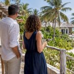 Couple comparing Zanzibar resort suites and villas