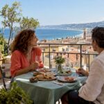 Couple overlooking Nice rooftops during lunch