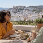 Couple lunching above Ibiza’s built-up landscape